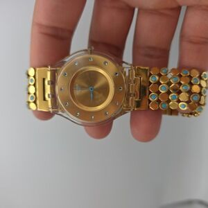 Swatch Womens Dress Watch Gold Dial Turquoise Stone Bracelet Clear Case Quartz